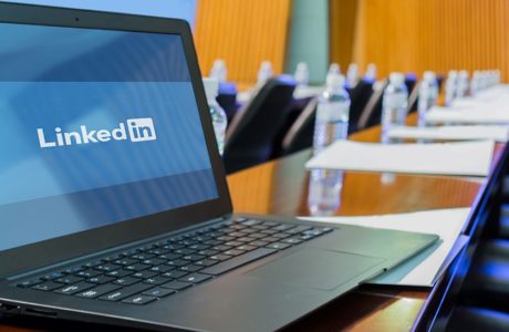 Laptop Displaying LinkedIn In Corporate Boardroom