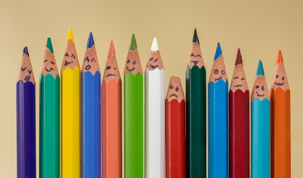 Row of colored pencils with smiling faces