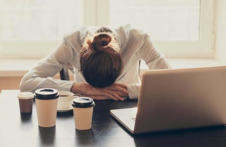 Exhausted And Frustrated HR Leader With Head On Desk