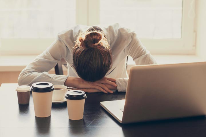 Exhausted and frustrated HR leader with head on desk