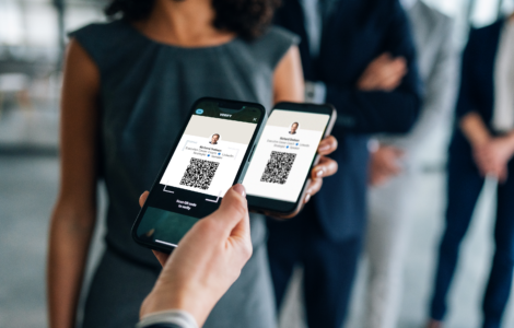 Two Business People Using Mobile Phones To Scan A LinkedIn QR Code At A Networking Event